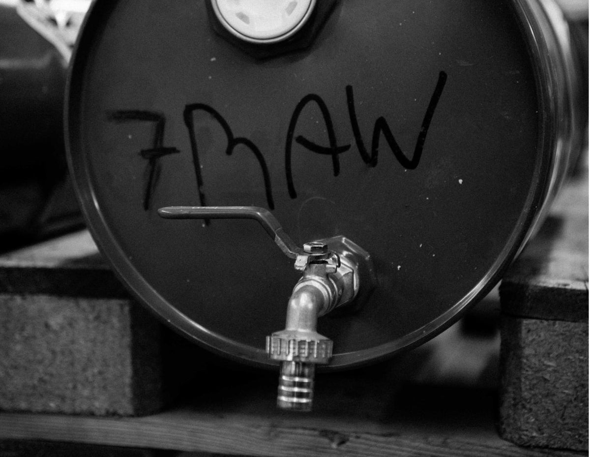 Steel drum marked 7RAW by hand